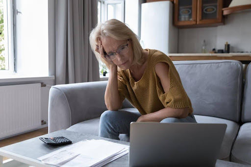 Overwhelmed Ontario homeowner sitting at a table with paperwork